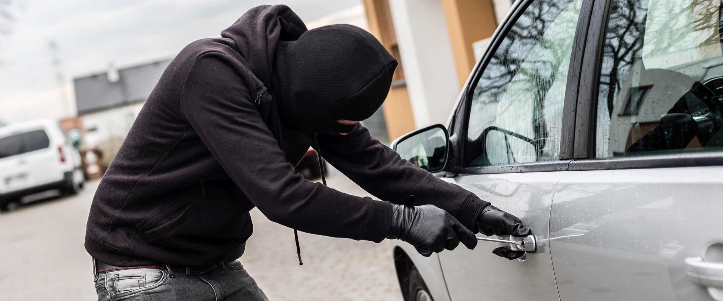 Thief breaking into car