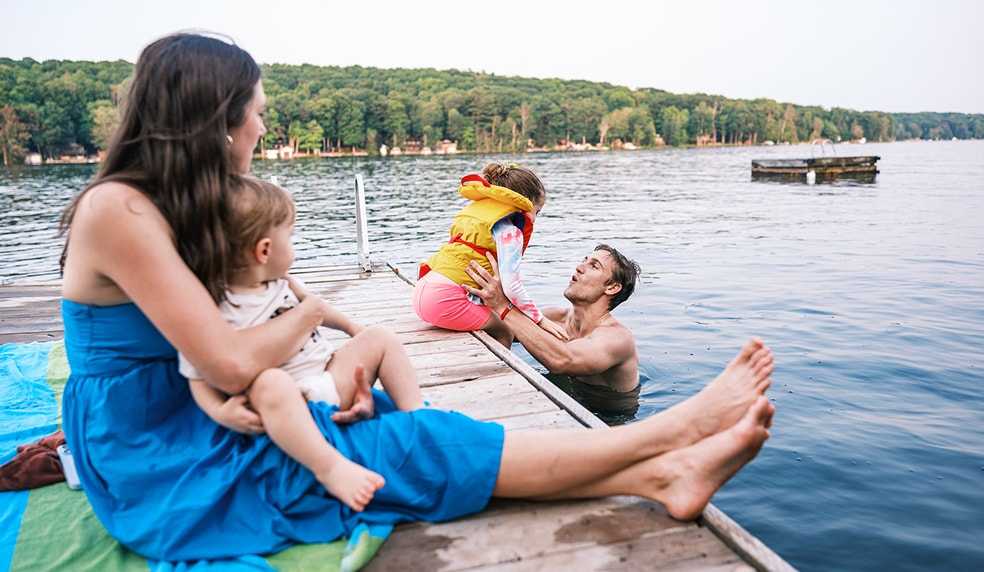 Couple with kids on the lake