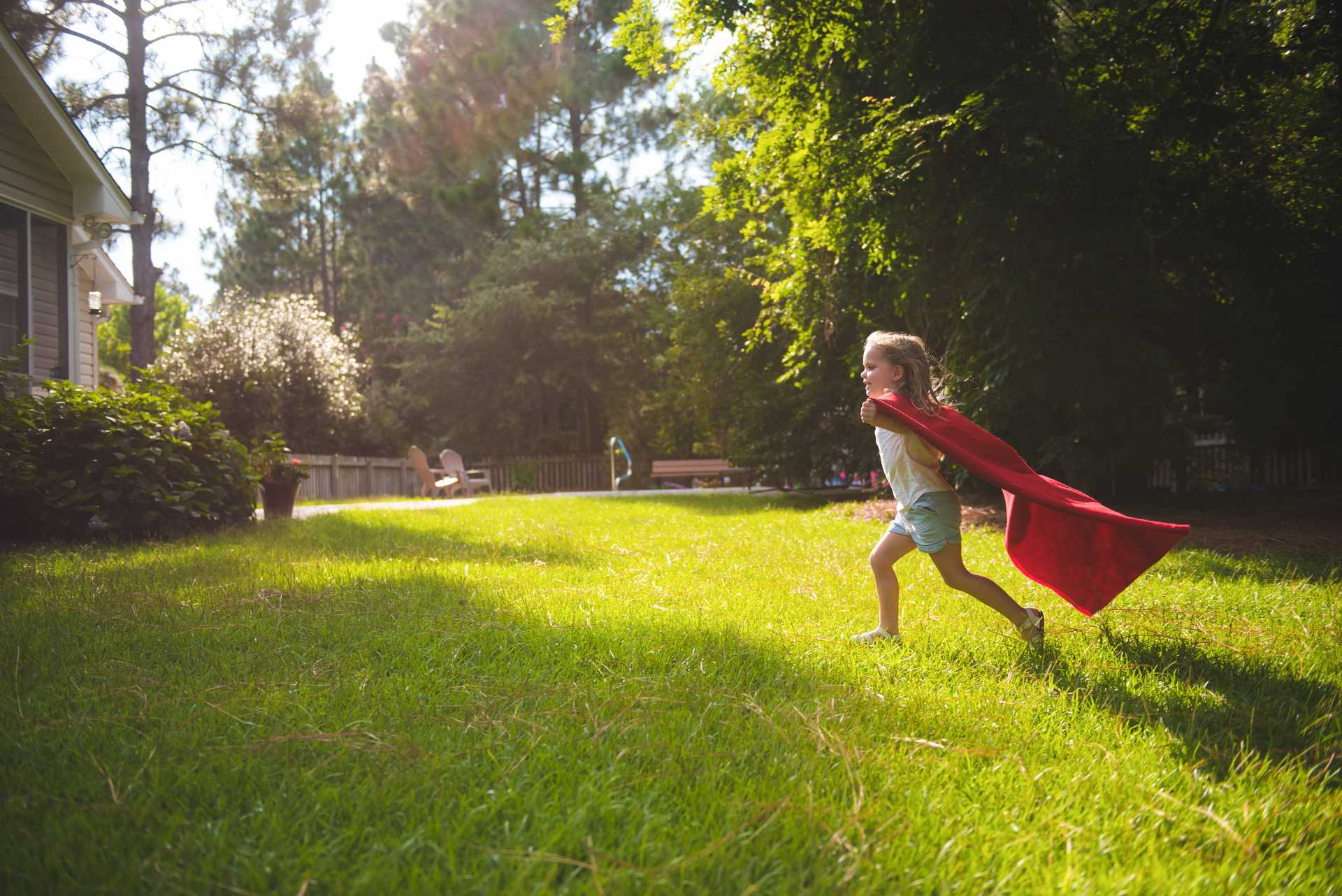Girl running with red cape