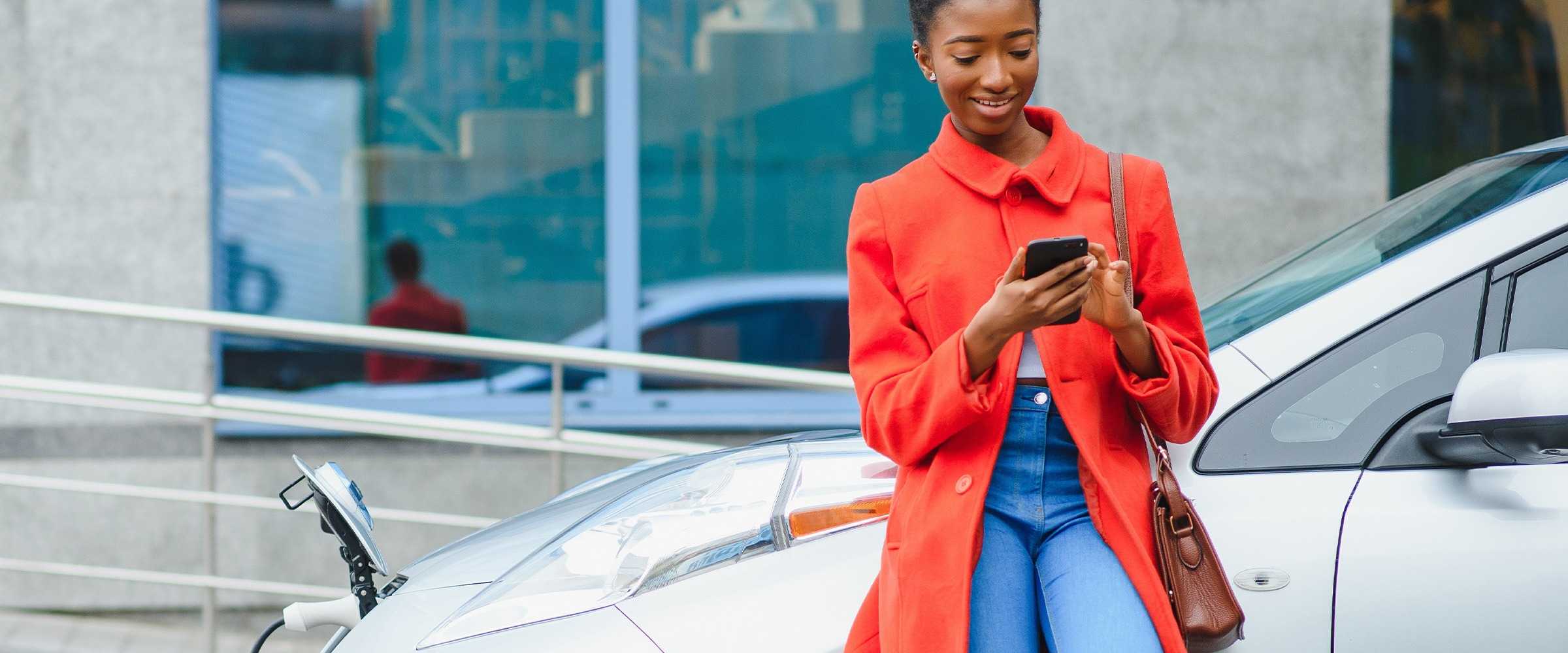 Lady with the phone and electric vehicle